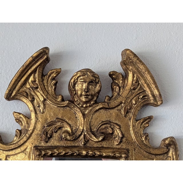 Stunning early 19th-century Italian hand-carved gold leaf neoclassical style accent mirror. Beautifully decorated scroll...