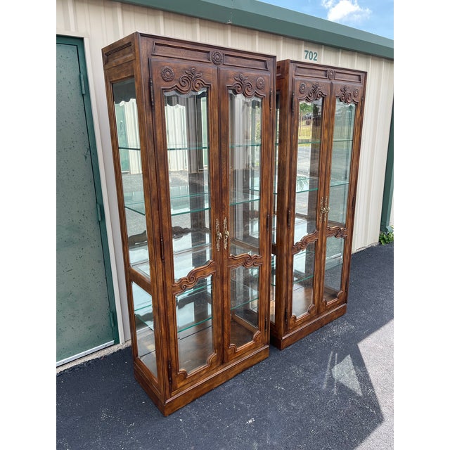 A pair of Drexel Heritage “Old Continent” collection display cabinets. Made of oak with heavy French country styles, this...