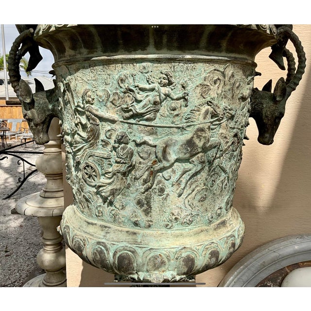 Pair of Early 20h century Oversized French Classical Figural Bronze Urns/Planters. Planters feature stag heads on each...