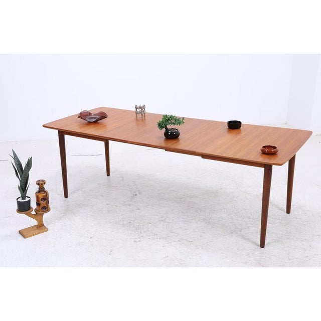 Vintage teak dining table by Gustav Bahus with a beautifully grained top and softly rounded corners. The tabletop can be...