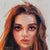 This oil on panel artwork features a close-up portrait of a young woman, capturing her intense gaze and expressive...