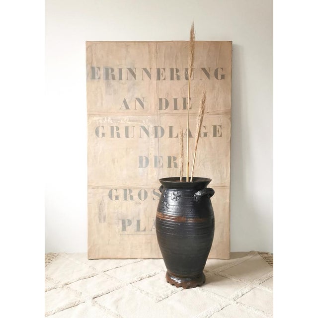 This large, antique stoneware pot was made as a storage vessel in Germany in the 1870s. The crown or serrated base is...