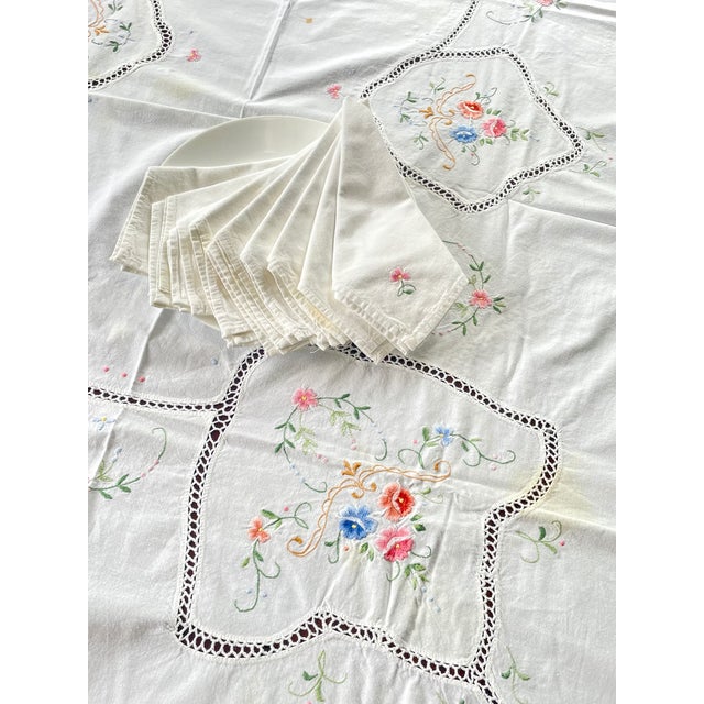 A beautiful vintage handmade table linen set featuring one large rectangular tablecloth accompanied by nine matching...