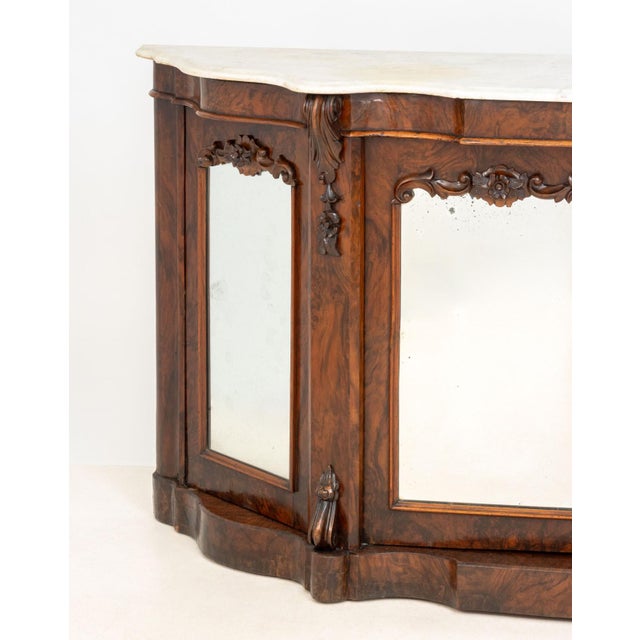 Victorian Walnut Mirrored Credenza, with white marble top above four mirror paneled doors opening to two shelves. 35" H x...