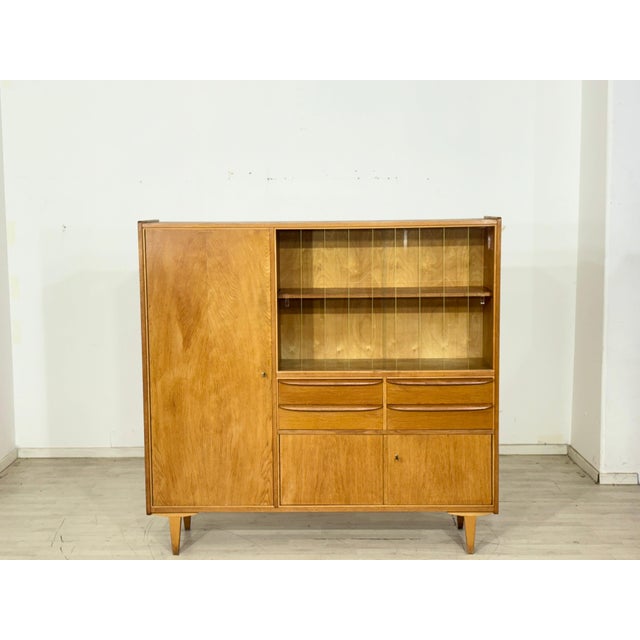 Spacious vintage highboard from the 1960s. This piece of furniture impresses with its clean mid-century design, beautiful...