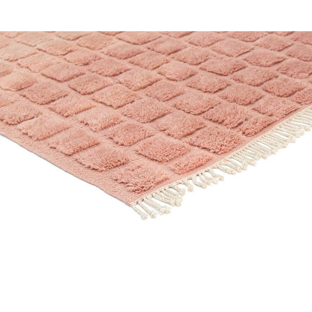 Warm terracotta, textured into a modern grid. This hand-knotted Moroccan wool rug features a structured square pattern...
