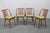 Set of four Šuman Mid-Century dining chairs designed and produced in 1960s Czechoslovakia. Each chair features a curved...