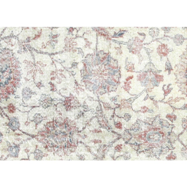 This vintage Turkish Oushak rug measures 9'3" x 12'2" and is handwoven in the Oushak region of Western Turkey using wool...