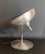 Large lamp made entirely of brushed aluminum, can be adjusted to different positions and is turned on with a foot pedal....