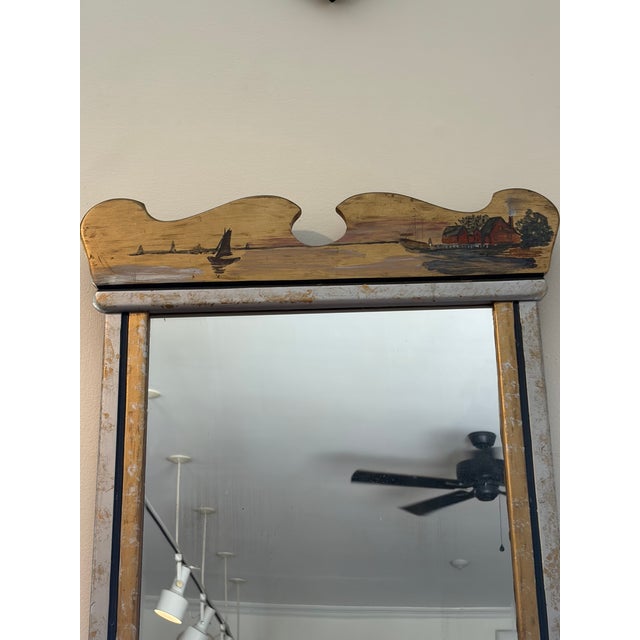 Charming Swedish folk art Trumeau mirror with a hand-painted coastal landscape crest depicting sailboats and cottages. Its...