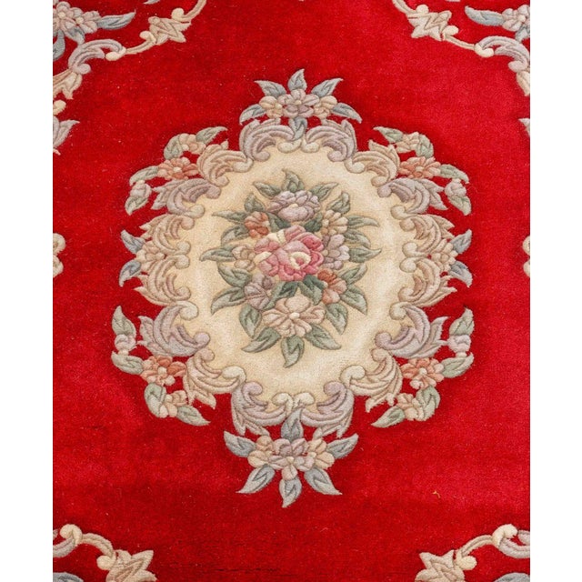 Chinese Floral Motif Rug, with central rose flower medallion on a red ground. 6' 9" L x 4' W. Provenance: From a West End...
