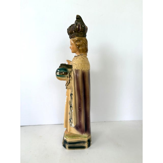 This vintage glazed ceramic sculpture represents the Infant Jesus of Prague, one of the most iconic and widely venerated...