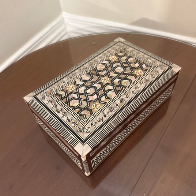 A high quality mosaic wood jewelry box with mother of pearl inlay, that would look stylish on a coffee table or displayed...