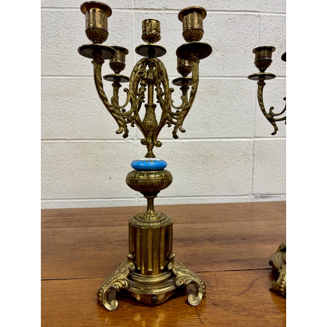This is a matched pair of antique gilt-bronze (Ormolu style) five-arm candelabra, measuring 15 ⅛ inches tall with a 6.25”...