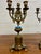 This is a matched pair of antique gilt-bronze (Ormolu style) five-arm candelabra, measuring 15 ⅛ inches tall with a 6.25”...