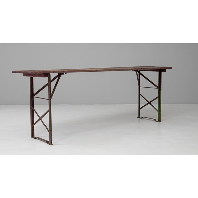 This 20th Century French metal and wooden folding garden table captures the utilitarian charm and easy functionality of...