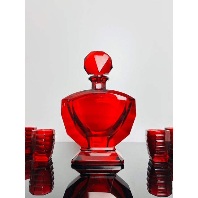 Complete seven-piece Art-deco Moser glass set comprising one ruby red decanter with stopper and six matching shot glasses....
