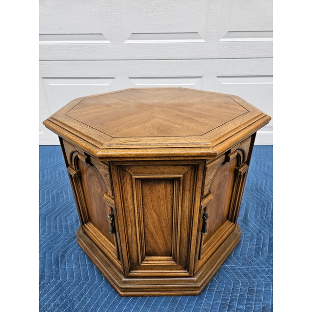 A classic large octagonal side table with storage space. This piece features two doors with brass pulls and one fixed...