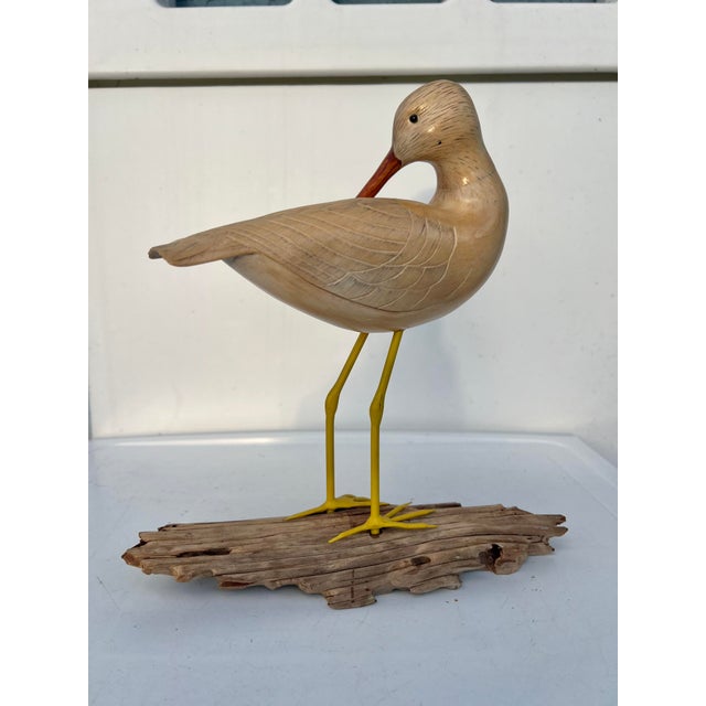 Vintage hand-carved wooden shorebird (sandpiper) figurine, mounted on a driftwood base. Features a carved wood body,...