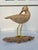 Vintage hand-carved wooden shorebird (sandpiper) figurine, mounted on a driftwood base. Features a carved wood body,...
