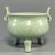 This is a Chinese Longquan celadon tripod censer with twin upright handles. Adopting classic ancient bronze ding shape,...