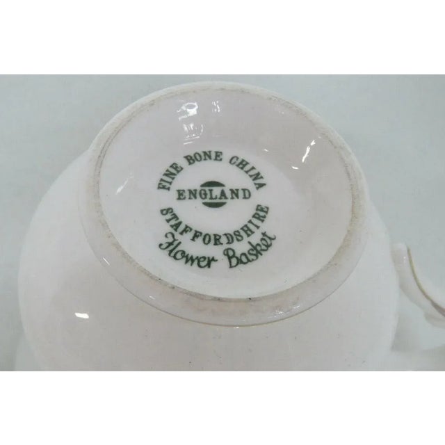 This gorgeous porcelain set of 3 cups and saucers is stamped on the bottom " Fine Bone China England Staffordshire Flower...