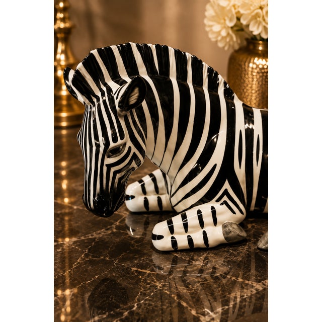 Make a bold statement with this vintage Tilso Japan reclining zebra sculpture, a striking example of Mid-Century...