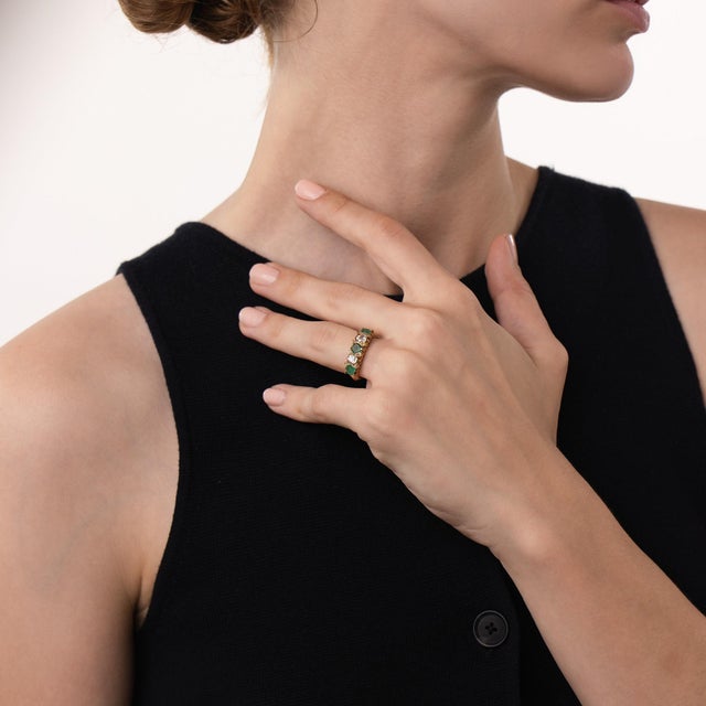 This beautiful Edwardian emerald and diamond ring is a refined antique design from the 1910’s, featuring 3 round cut...