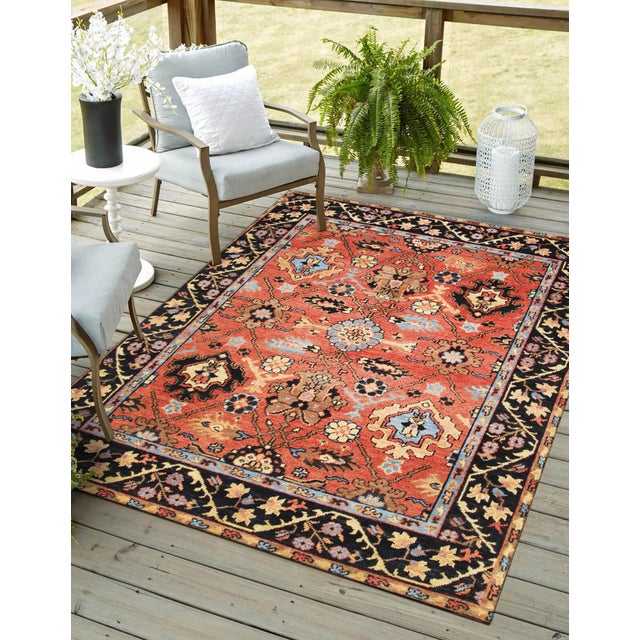 A hand-knotted wool rug, made in India and measuring 7'7"' x 9'11"'. Floral drawing carried across the field inside a...