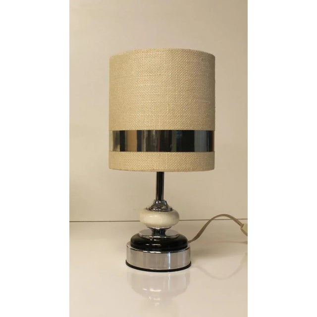 Pair of Delmas brand lamps. The ecru linen effect lampshades, enhanced on the outside and inside with aluminum edging,...