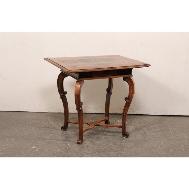 An Italian side table with veneer inlays and single drawer from the 18th century. This antique accent table from Italy...