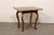 An Italian side table with veneer inlays and single drawer from the 18th century. This antique accent table from Italy...