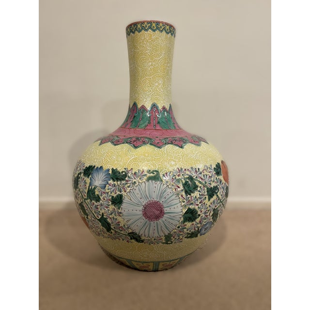 The vase is superbly potted with a globular body rising to a cylindrical neck supported on a countersunk base. Yellow...