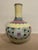 The vase is superbly potted with a globular body rising to a cylindrical neck supported on a countersunk base. Yellow...
