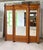 A late 19th-century wardrobe with three doors and drawers. The uprights and ornamentation are in imitation bamboo. The...