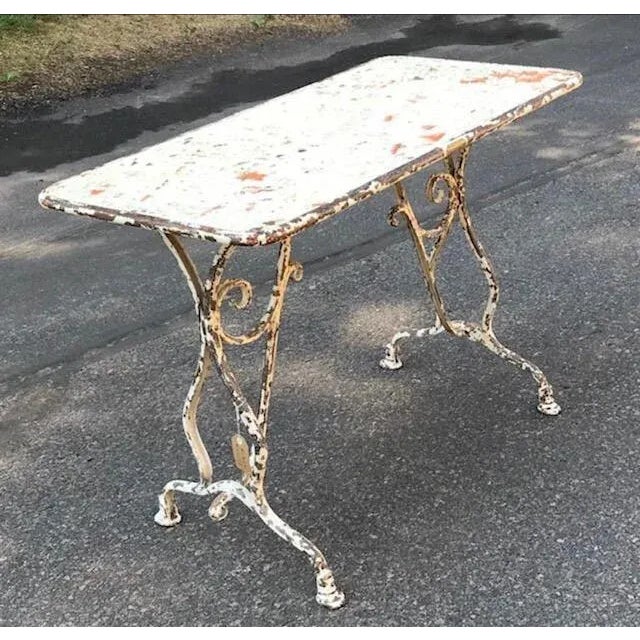 A 19th century French iron table from Arras with horse hoof feet. Measures 39.5"W x 20"D x 28"H. Full of French country...