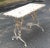 A 19th century French iron table from Arras with horse hoof feet. Measures 39.5"W x 20"D x 28"H. Full of French country...