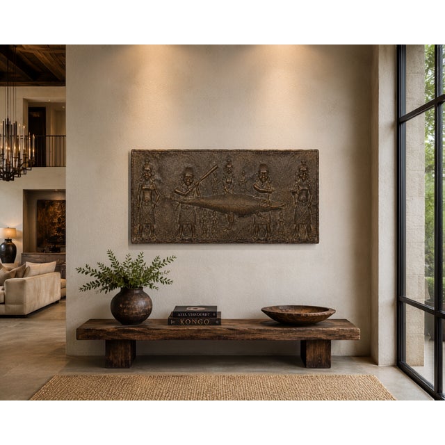 There are objects that decorate a room. This one redefines it. This large cast metal relief plaque works within one of the...