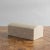 Unique natural off-white and tan stone jewelry box crafted in the shape of a treasure chest. Felted interior provides a...