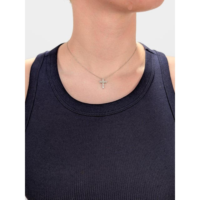 A fine vintage signed platinum and diamond pendant necklace. By Tiffany & Co. In platinum. Set with 11 prong-set round cut...
