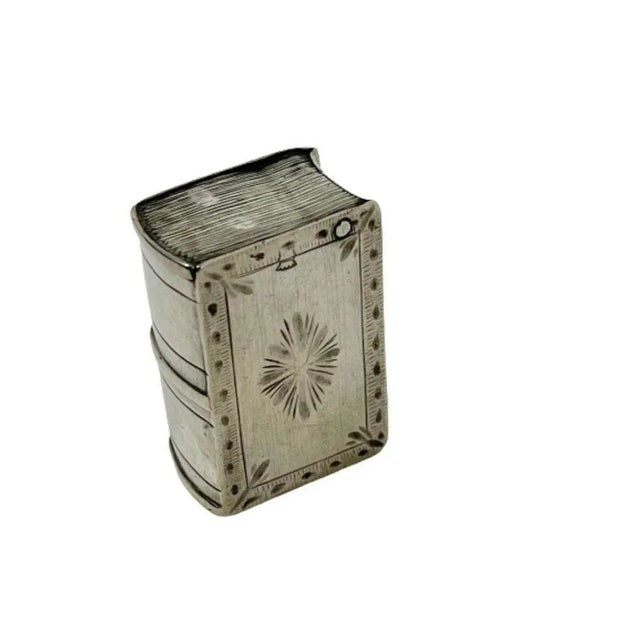 A 19th century silver loderein box in the shape of a book A silver loderein box in the shape of a book with engraving....