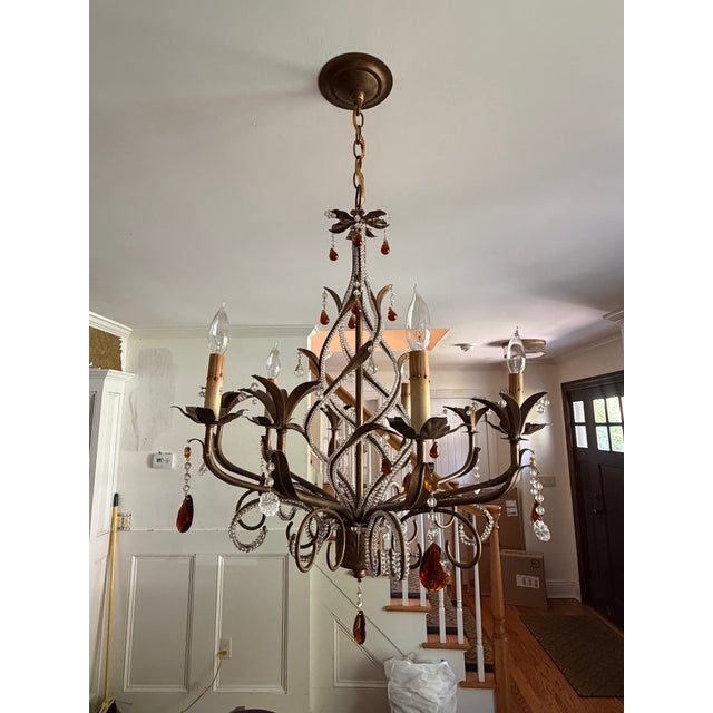 A beautiful and increasingly difficult-to-find Currey & Company Isabella Chandelier, model 9596, featuring an elaborate...