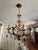 A beautiful and increasingly difficult-to-find Currey & Company Isabella Chandelier, model 9596, featuring an elaborate...