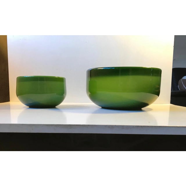 A matching set of Palet Bowls in cased green opaline glass. Designed by Michael Bang for Holmegaard, circa 1970. The set...