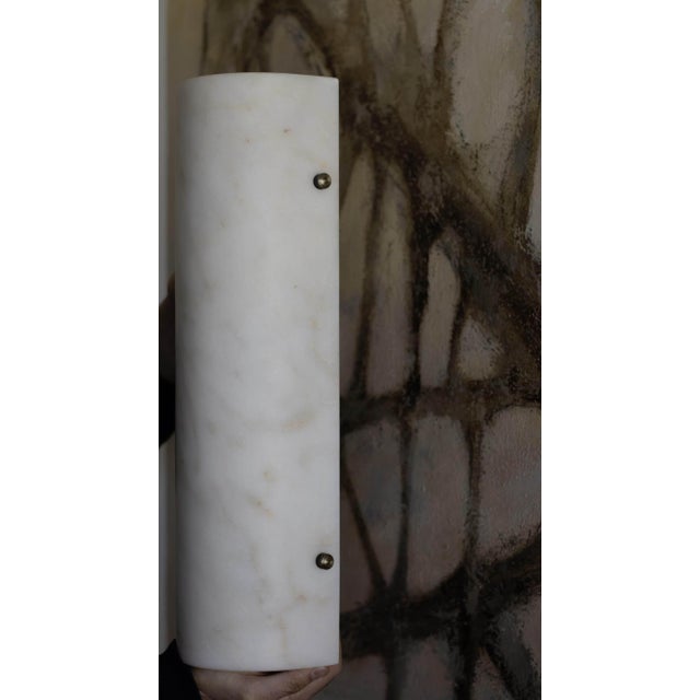 The Ephesus Sconce is made from solid alabaster with aged brass fasteners. When illuminated, the stone reveals its natural...