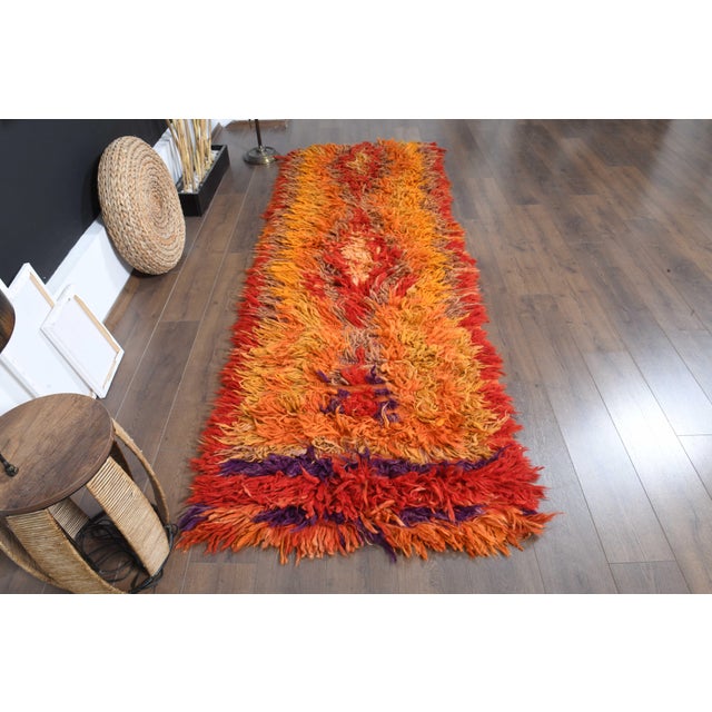 Vintage Hand-Knotted runner rug is a semi-antique vintage area rug. The '70s Eastern region of Anatolia's unique rug is...