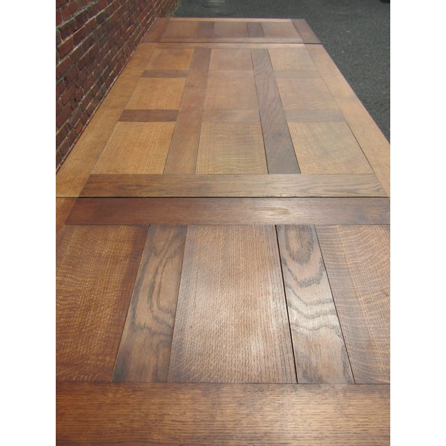 French Provincial style draw leaf dining table, the well-figured oak parquet top with two pull-out leaves, above the...