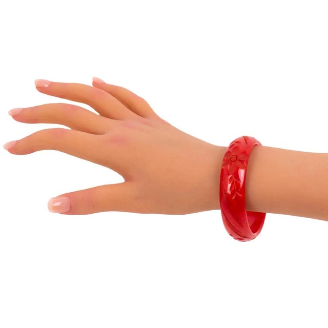 This is a gorgeous magenta-red marble Bakelite carved bracelet bangle. It features a spacer domed shape with deep,...