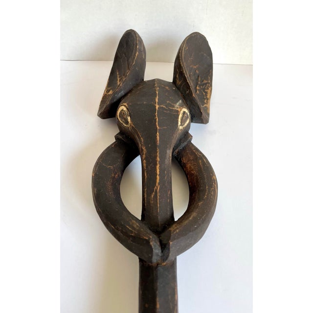 This vintage African wall carving features a bold hand-carved elephant head form in the tradition of Babanki wood...