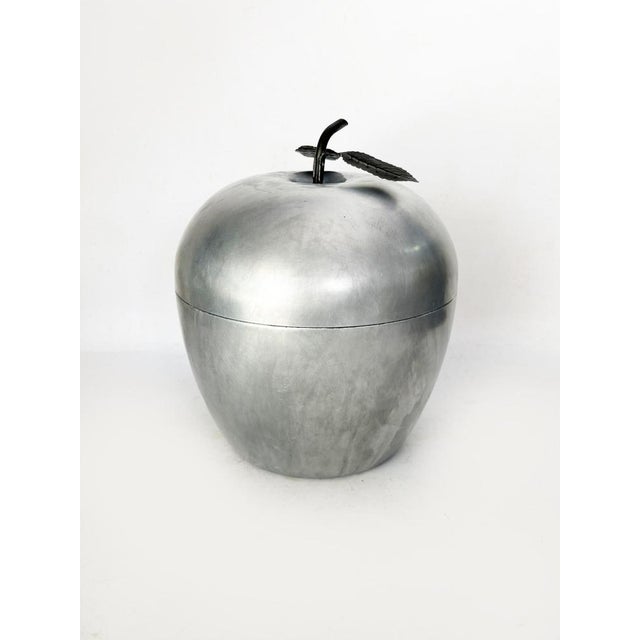 Apple-shaped aluminum ice bucket, an iconic piece of 1970s design, both functional and sculptural. This ice bucket is...